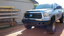 2007-2021 Toyota Tundra equipped with Steelcraft Fortis Front Bumper 71-13380 in textured black finish, customer review from NAPA Online highlighting tight body fitment, aggressive off-road styling, steel construction, and superior front-end protection.